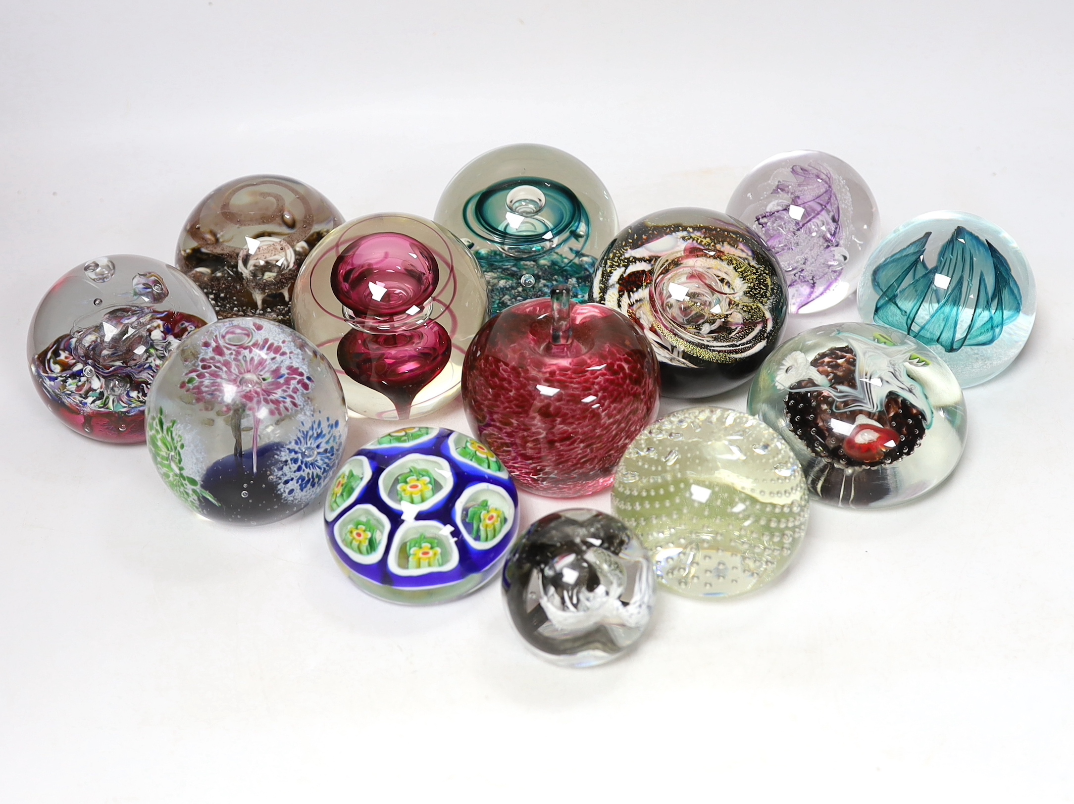 Thirteen glass paperweights including Caithness and Murano, largest 9cm in diameter